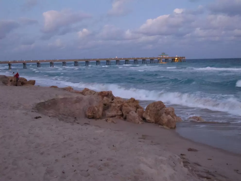 The rocks at the shore, and the pier.