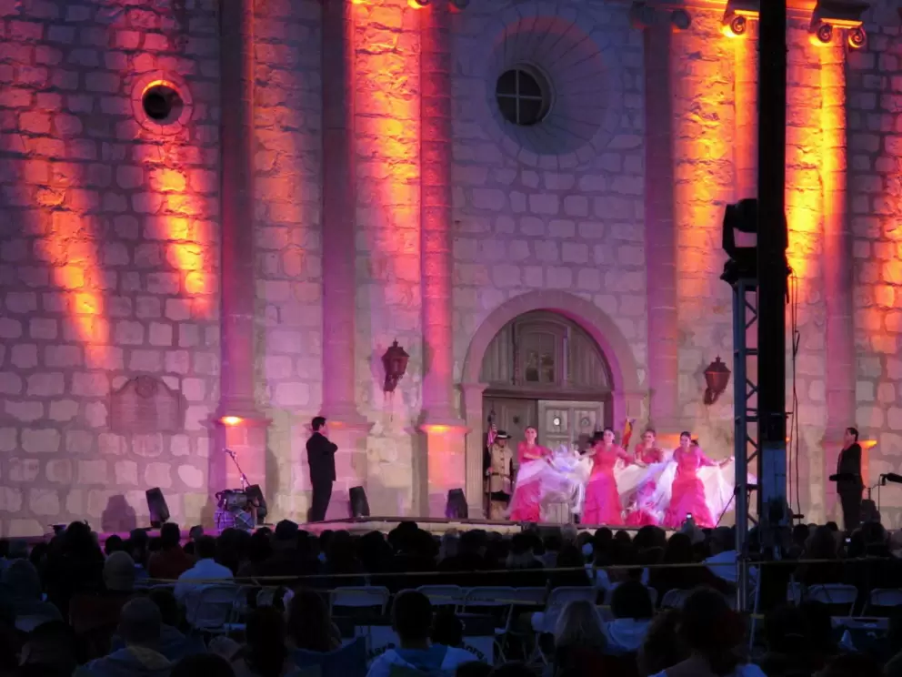 Pink ladies in front of the pink-lit mission!