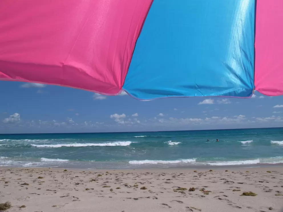 Beach umbrella and the enticing water.