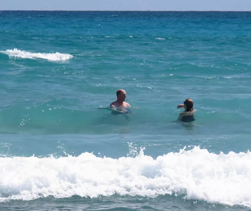 A couple enjoys the clear, warm water.