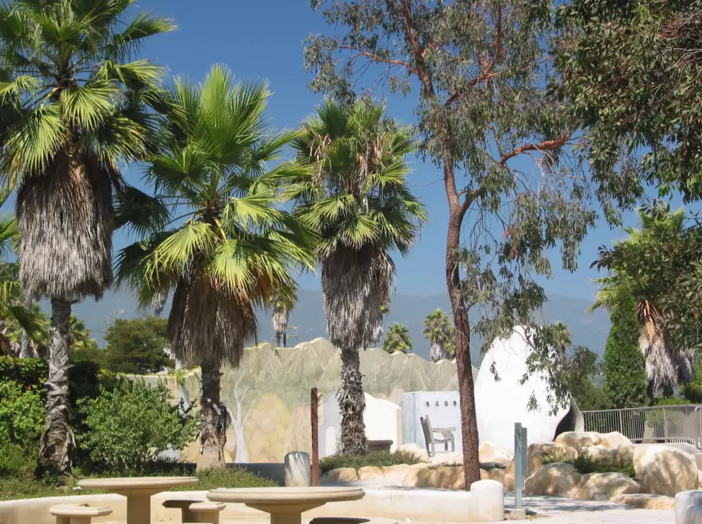The Spanish adobe village behind the cave and playground.