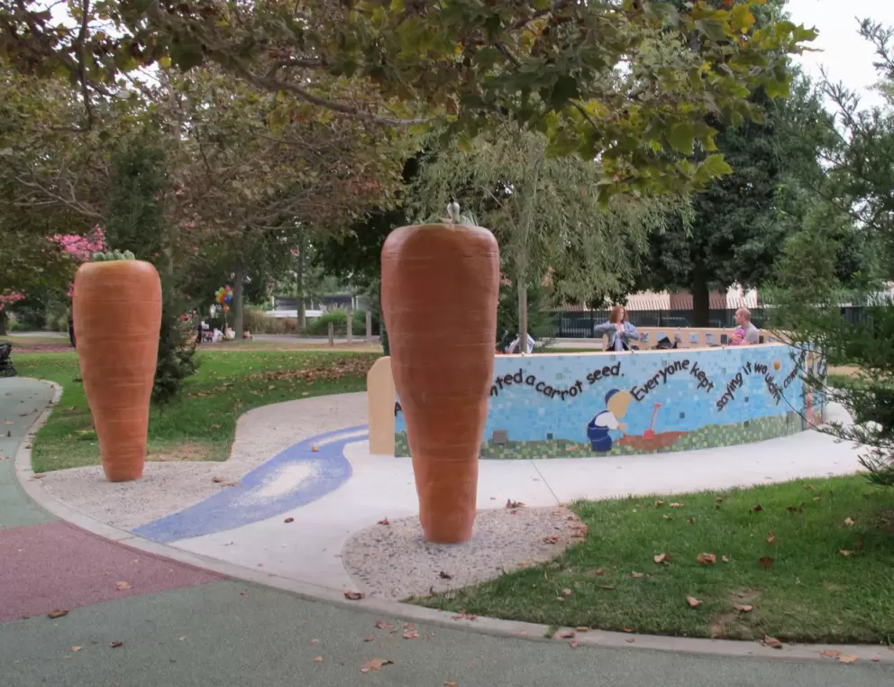 Parents take a break at the carrot/garden bench.