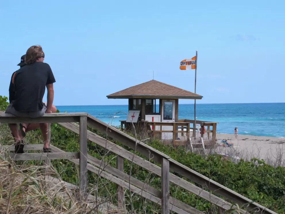 Flag at Juno Beach indicating that only surfers are allowed in the water left of the pier (on days when the swell is good).