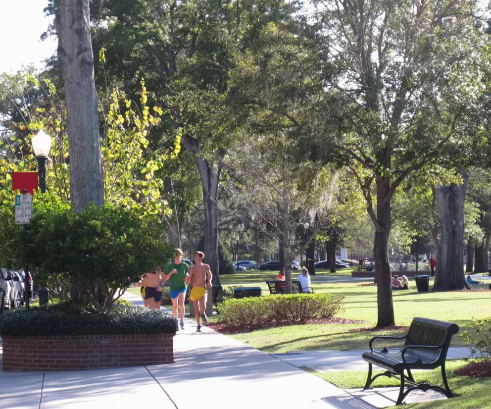 College guys jog in the park.