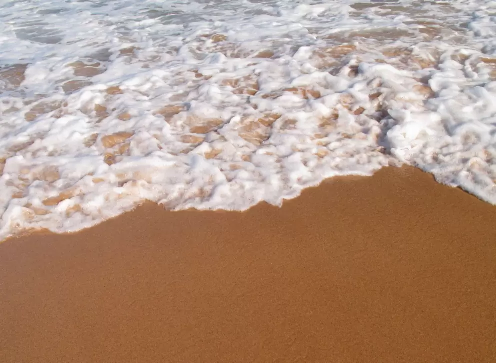 White foam on colorful shore.