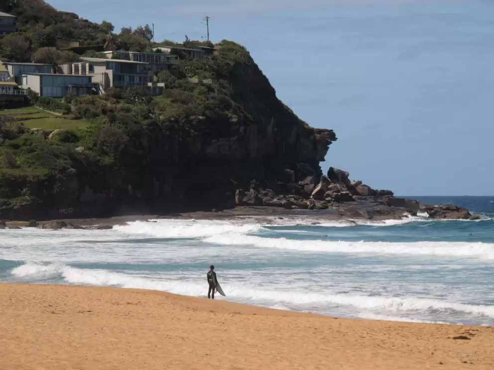 Surfer looking out to the headland.