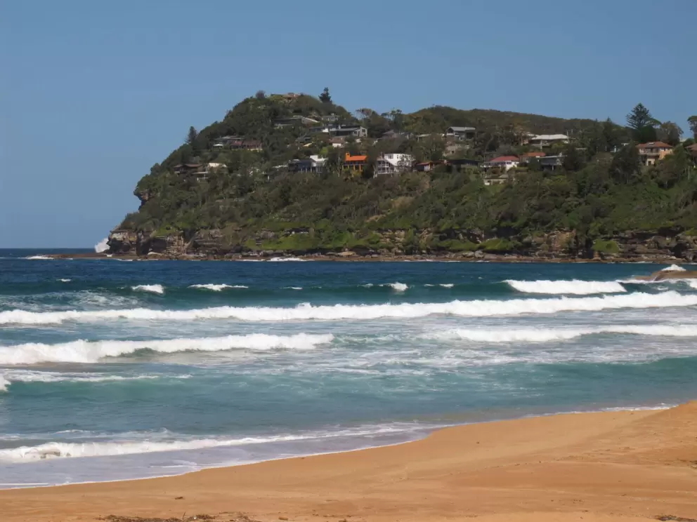 The other headland and lucky homes perched above the sea.