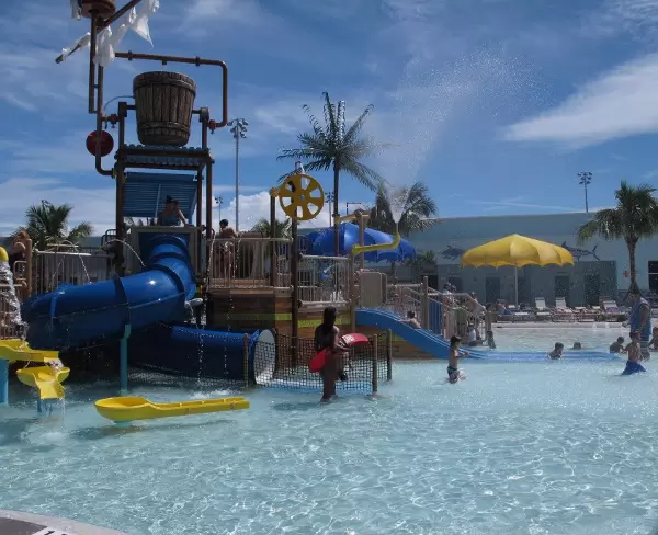 Clear, sparkly water and a pirate ship with slides and sprayers.
