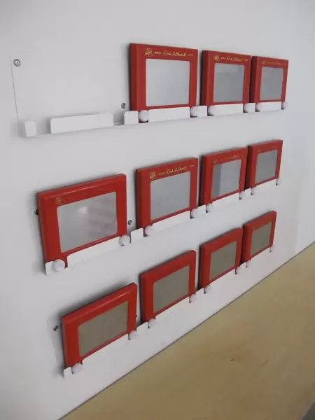 There are etch-a-sketch gizmos on the wall in the flashing lights area so parents can watch the art from different eras while kids keep their hands busy- smart!