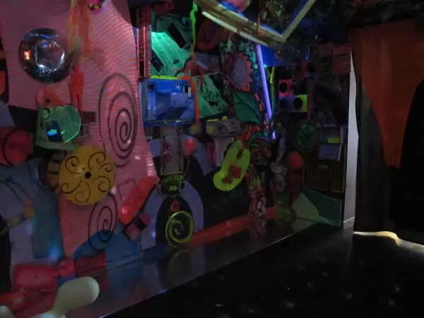 A dark area with Latin rhythms playing and disco lights.