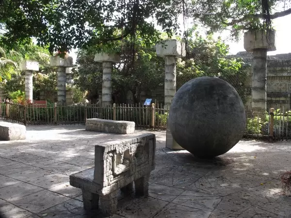 Columns, ball, and stone bench in the Tropics of the Americas section.