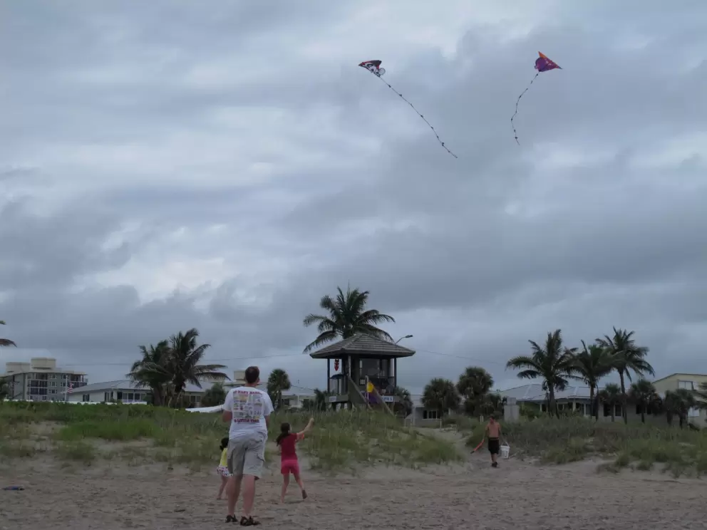 Flying kites on a stormy day at Delray Beach.