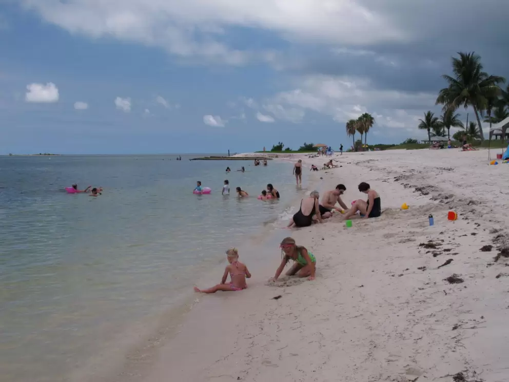 The beach curves around at the end.