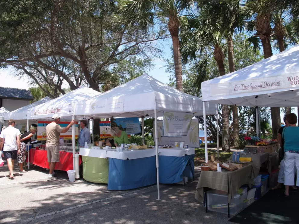 Stalls under tall trees at the Stuart Farmer's Market (Green Market).