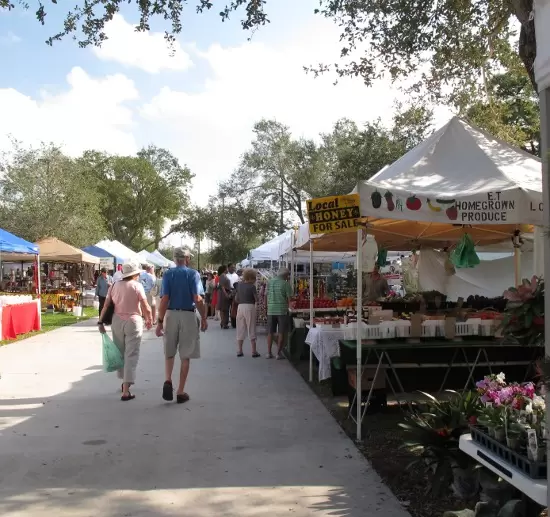 A couple walks past the homegrown produce stand.