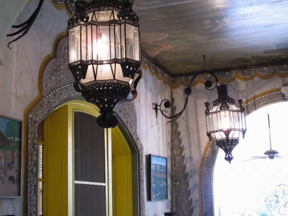 Ironwork lanterns and stenciled decorations.