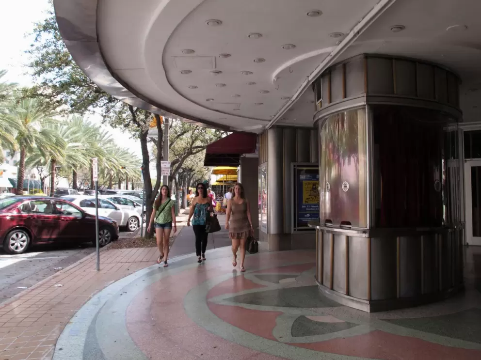 Three women walk along the Miracle Mile.