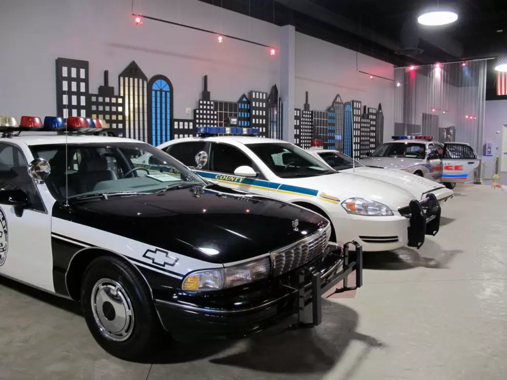 Police cars and city buildings.