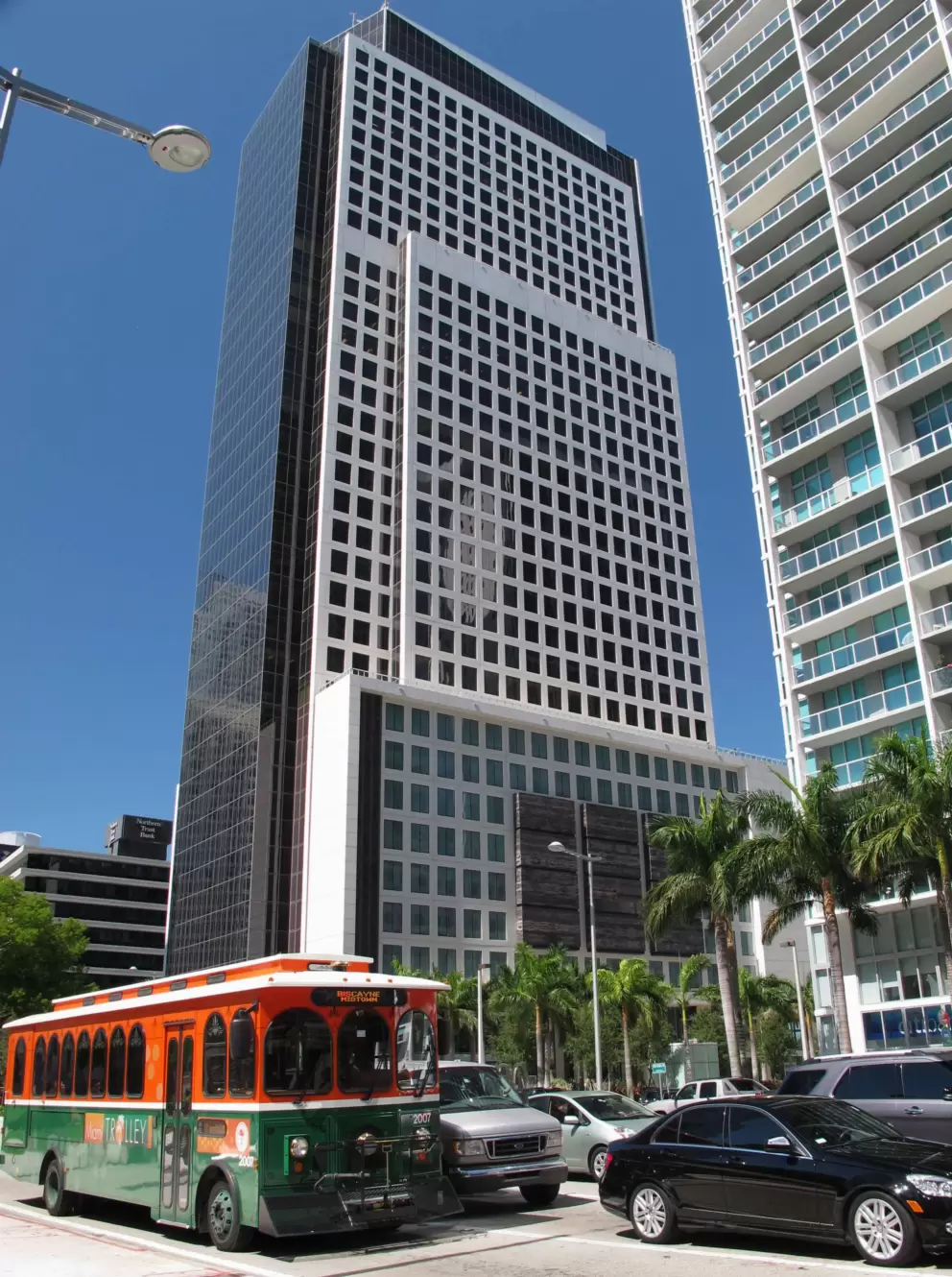 Trolley bus and skyscraper.