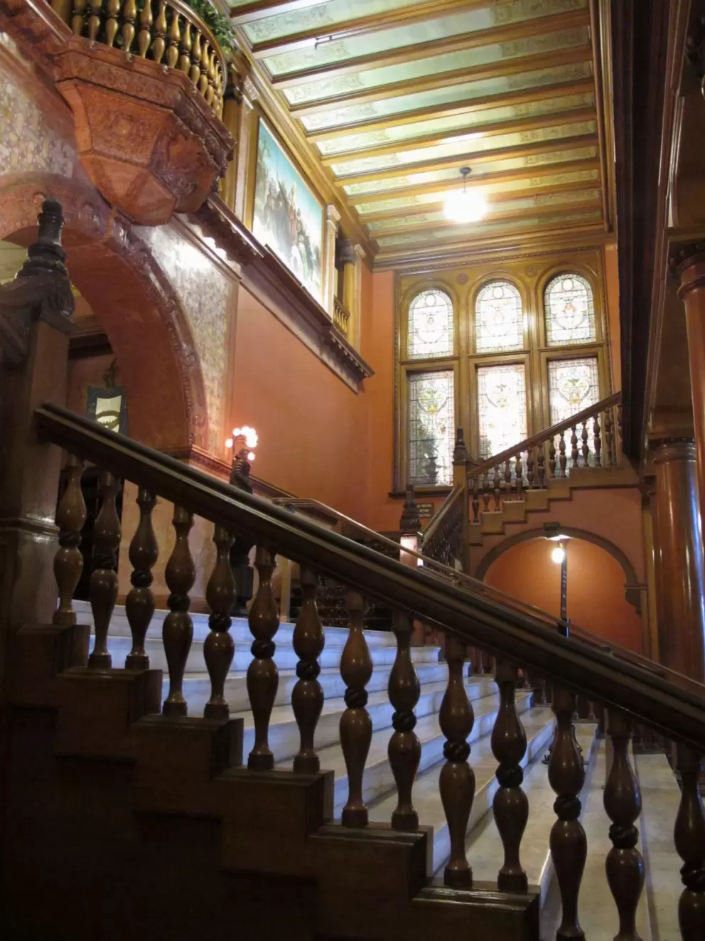 Stunning staircase and tiffany glass arched windows in Ponce de Leon Hall.