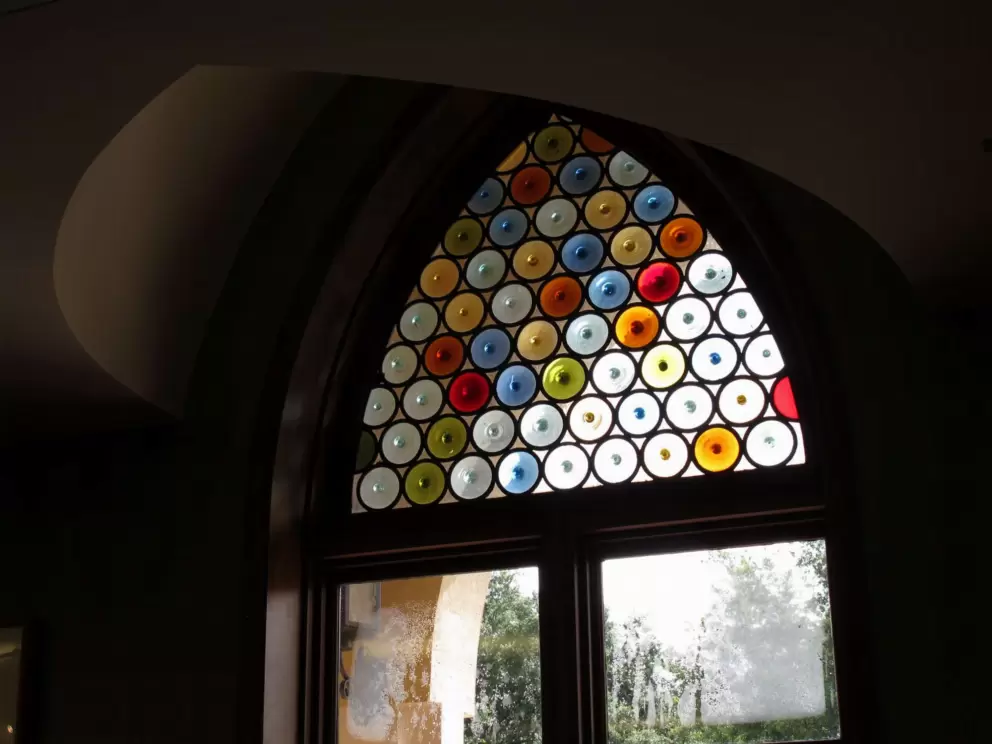 Stained glass window with colored circles in the library.