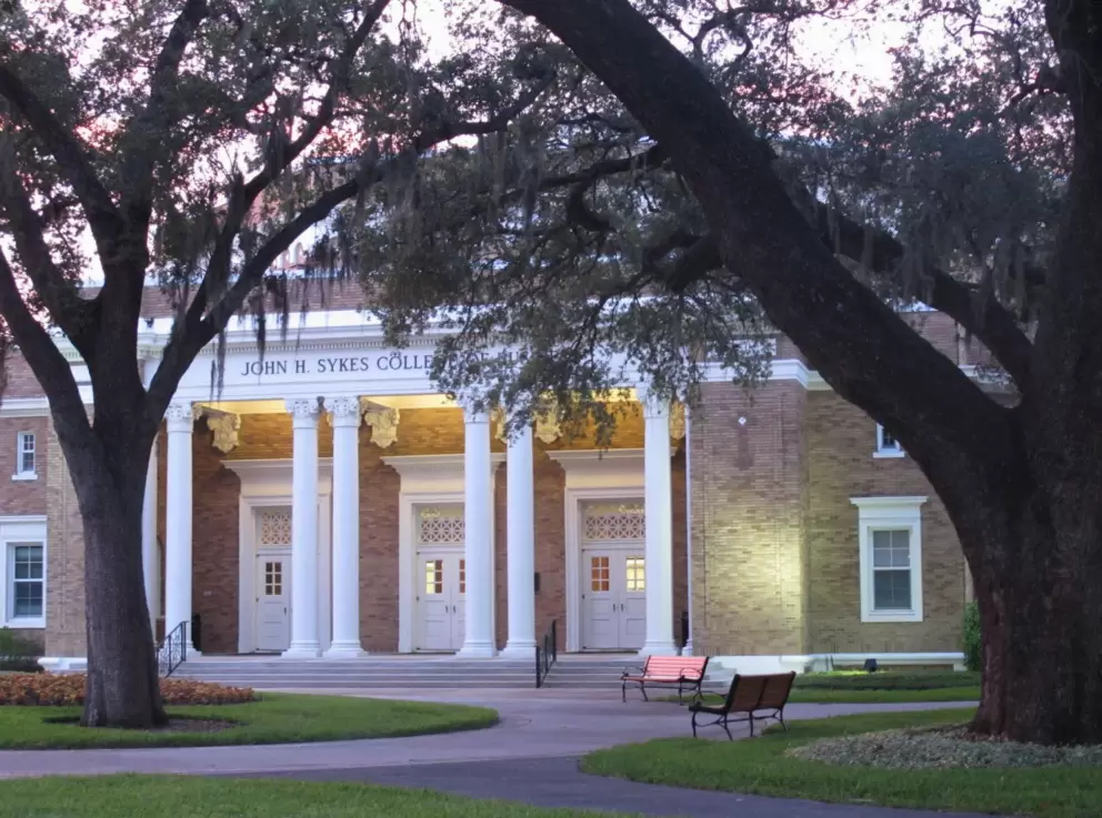 John Sykes College of Business with its pretty white columns and old trees.