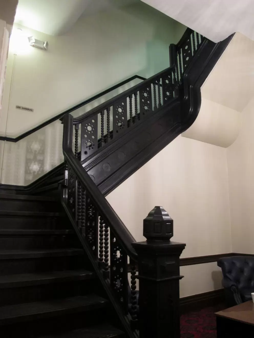 Ornate dark-wood staircase inside Plant Hall.