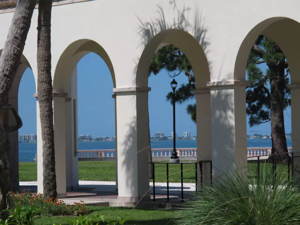 Ocean view through arched walkway.