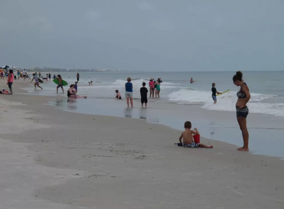 Mother and child at the shore enjoying the lively atmosphere.