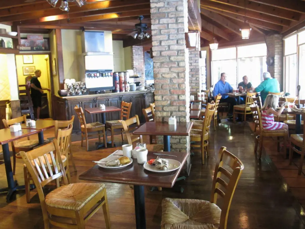 Cafe Madeleine's charming interior, with big windows looking out on St. Charles Ave.
