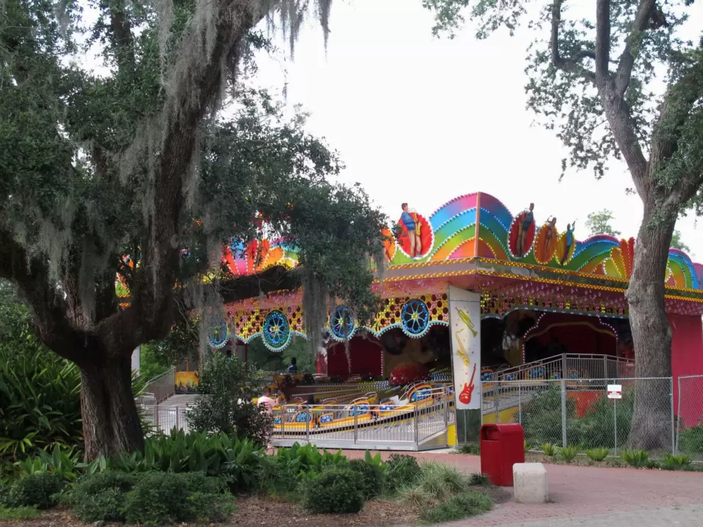 The colorful Musik Express ride amongst oak trees.