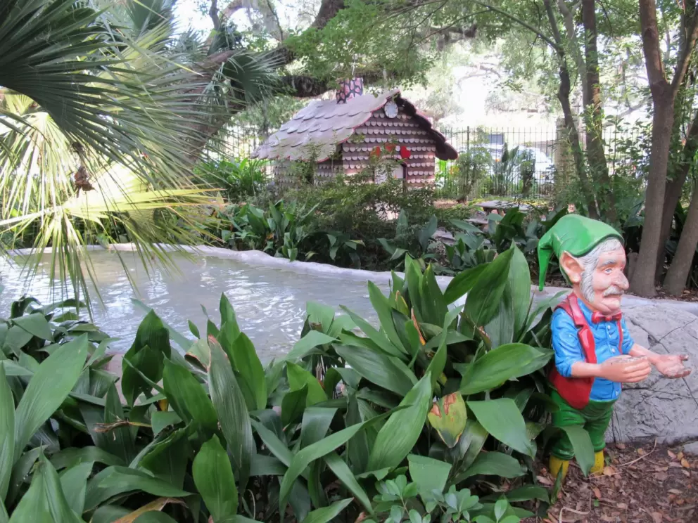 Dwarf, with gingerbread house in the background.