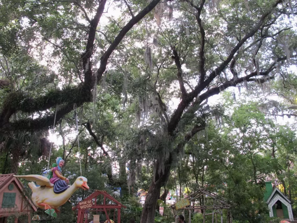 Mother Goose flying amidst the treetops.