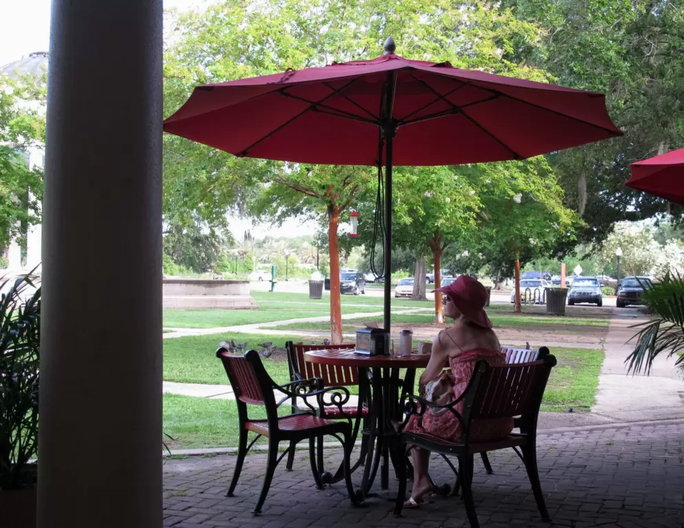 A lady sits at Morning Call, a concession stand that only sells beignets.