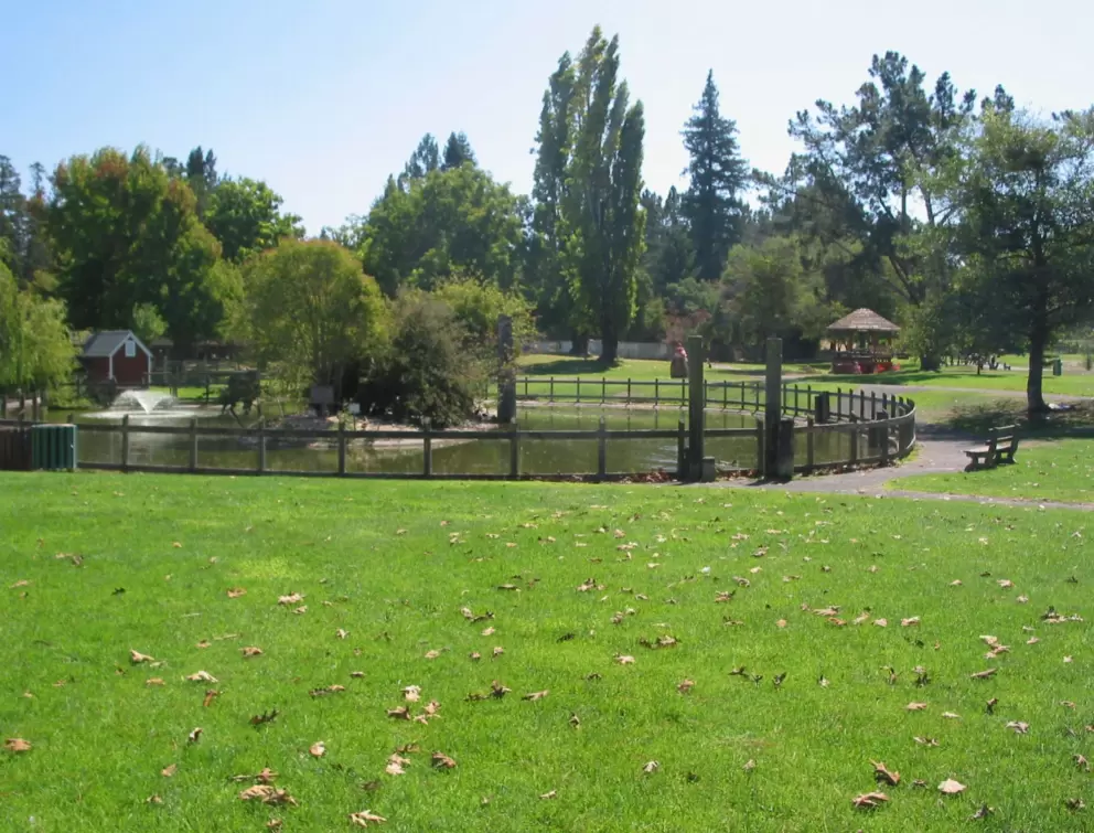 A gazebo, lake, hilly lawns, and tricycle paths at Willard Libby Park.