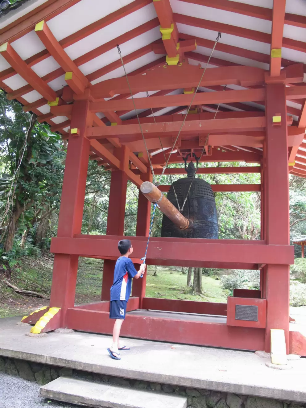 A boy rings the bell at the entrance.
