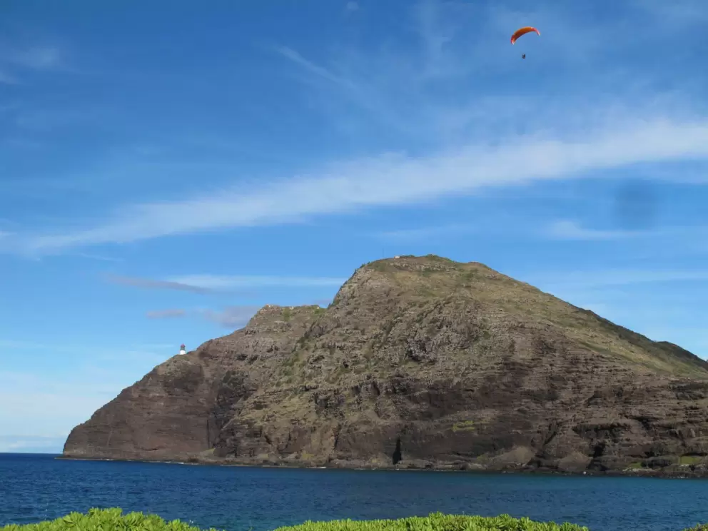 Paraglider, cliffs, and lighthouse.
