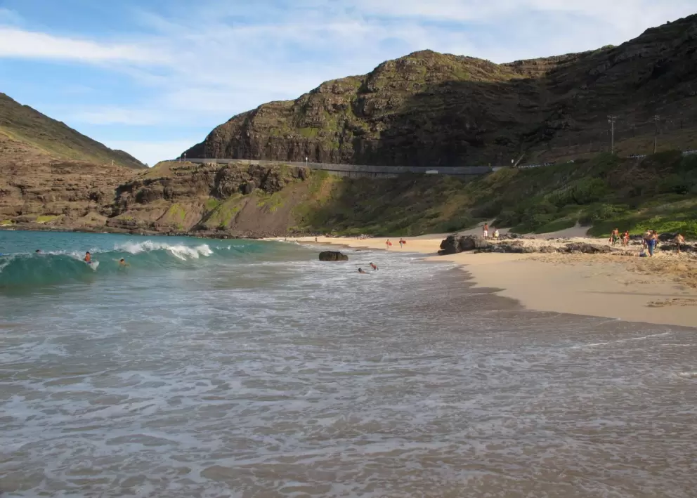 See the highway that hugs the cliff above the beach.