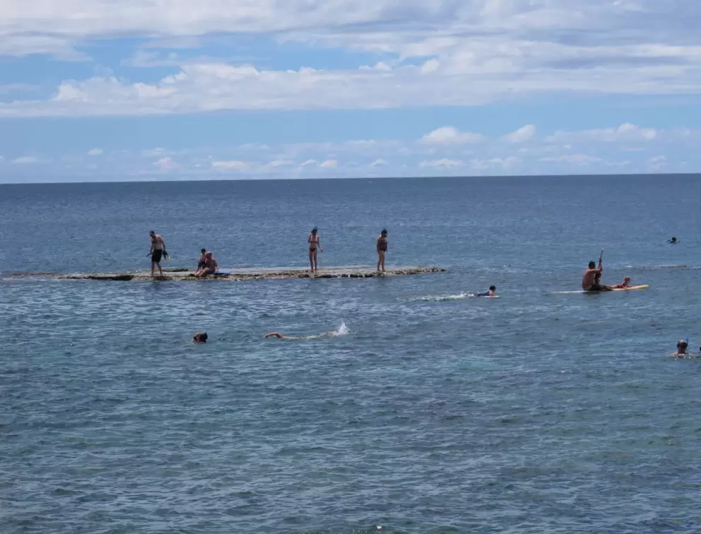 Kayaker and snorkelers at one of the three flat rocks.