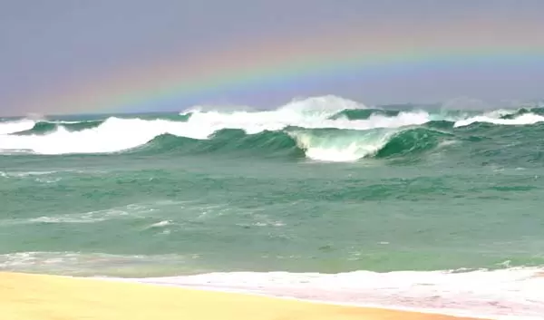 Rainbow over the winter waves.