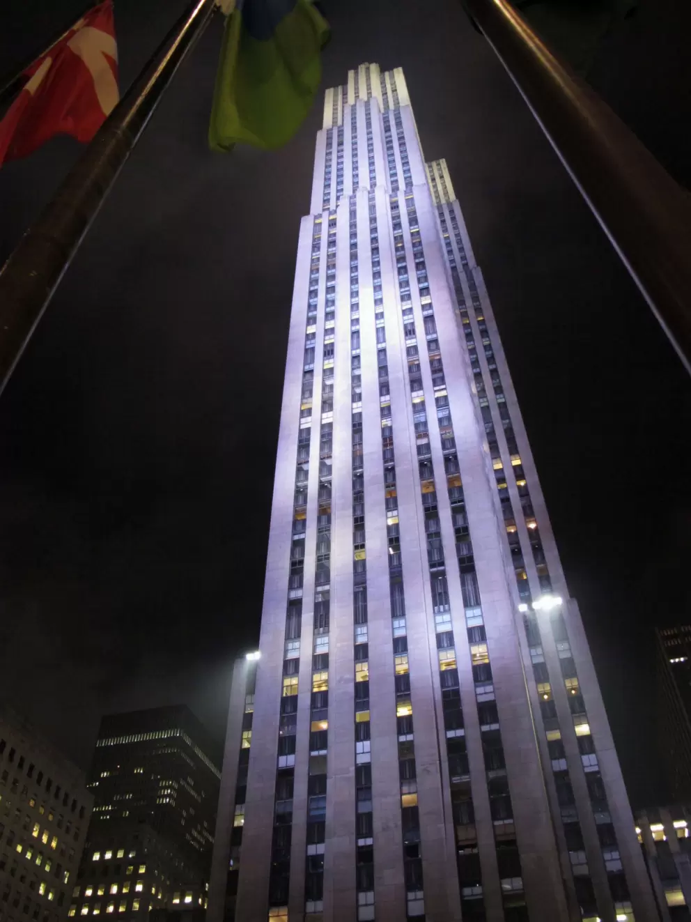 30 Rock building towers over the ice rink at night.