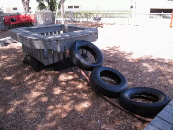 Huge wooden castle playground painted grey and not kept up that well right now.
