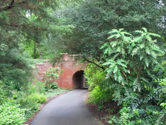 Walk under an arched brick bridge in the Spring Garden.