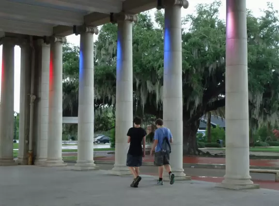 Teens playing Pokemon Go in the parthenon on a rainy evening.