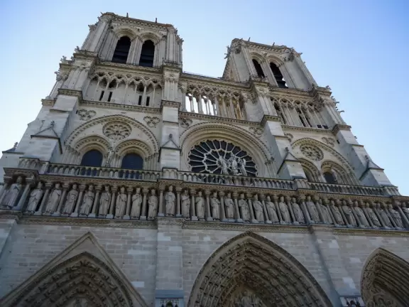 Iconic Gothic church on the Seine river with a huge plaza, Roman ruins, and gardens with play equipment.