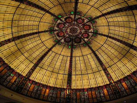 The Eiffel Tower, the Arc de Triomphe, and indoor cobblestone streets that look like Parisian streets, with Art-Nouveau Metro signs.