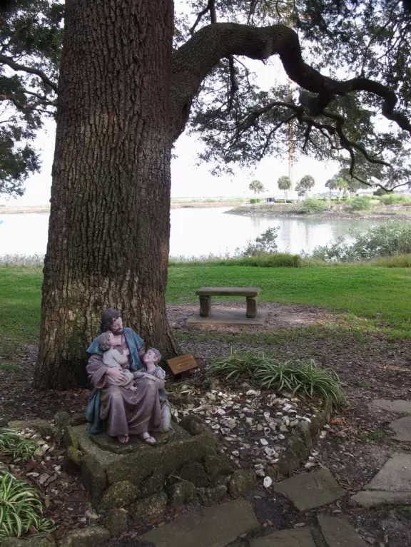 Sweet statue of Jesus and the children, under a gorgeous tree by the water.