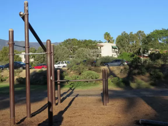 Park with calisthenics equipment and a playground.