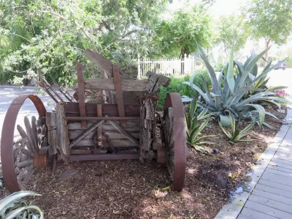 Small park with creek, adobe house, flower baskets, a few shops.