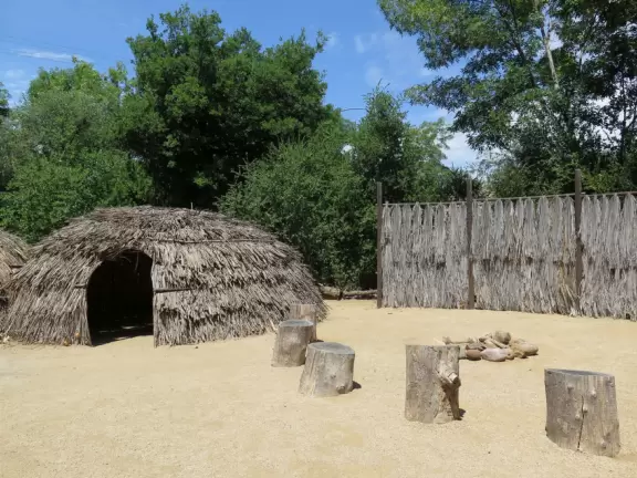 Small park with creek, adobe house, flower baskets, a few shops.